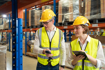 Teamwork of workers working in large warehouse retail store industry.Rack of stock storage. Interior of cargo in ecommerce and logistic concept. Depot. People lifestyle. Shipment service for container