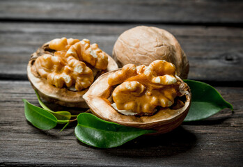 Peeled walnut with leaves .