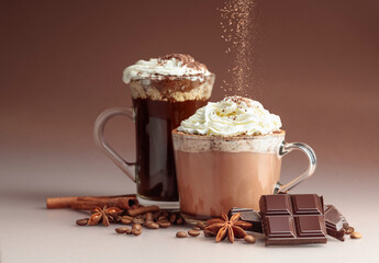 Hot chocolate and coffee with whipped cream sprinkled with chocolate crumbs.