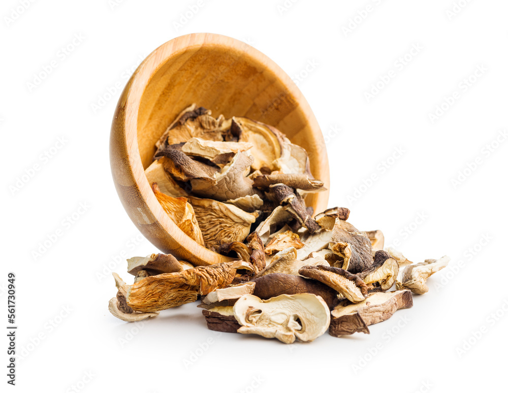 Wall mural various sliced dried mushrooms in bowl isolated on white background.