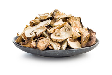 Various sliced dried mushrooms in plate isolated on white background.