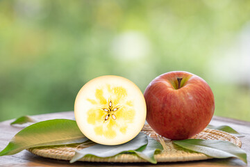 Red Kotoku Apple in the basket over green natural Blur background, Fresh Red Honey core Apple on bamboo mat.  .