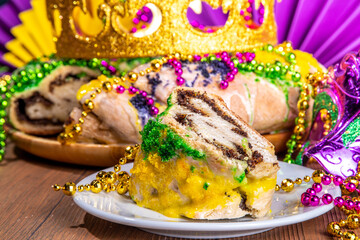 King Cake for Mardi Gras, traditional New Orlean Mardi Gras holiday pastry with plastic baby, with...