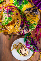 King Cake for Mardi Gras, traditional New Orlean Mardi Gras holiday pastry with plastic baby, with...