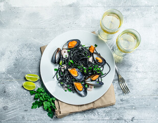 Mediterranean pasta. Spaghetti with cuttlefish ink, clams and white wine.