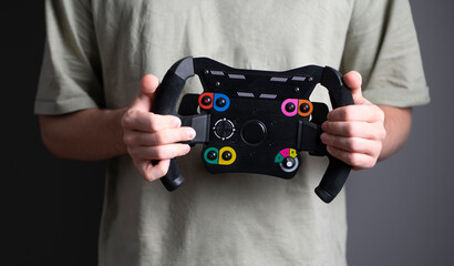 race driver holding a sport car steering wheel