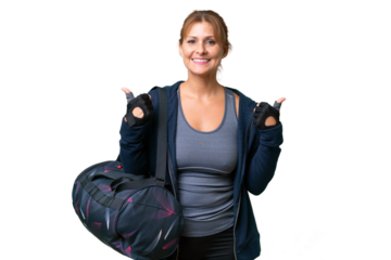 Middle-aged sport woman with sport bag over isolated background with thumbs up gesture and smiling