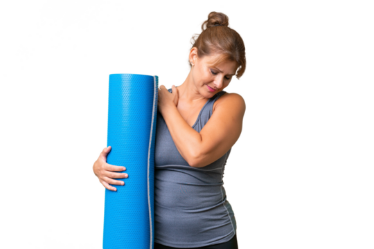 Middle-aged sport woman going to yoga classes while holding a mat over isolated background suffering from pain in shoulder for having made an effort