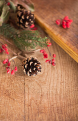 Obraz na płótnie Canvas Christmas background made of ipadoub spruce branches, cones, red viburnum berries on a dark wooden rustic background. Christmas background. Copy space for text, top view.