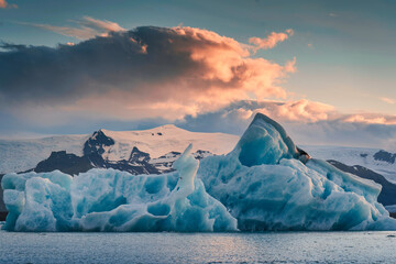Scenery of Jokulsarlon glacier lagoon with blue iceberg melting and sunset sky on summer