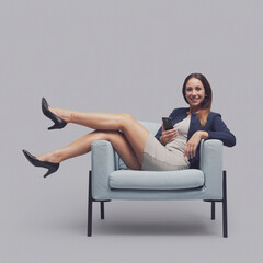 Confident businesswoman sitting with feet up