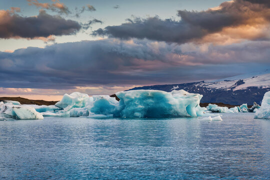 Scenery of Jokulsarlon glacier lagoon with blue iceberg melting and sunset sky on summer