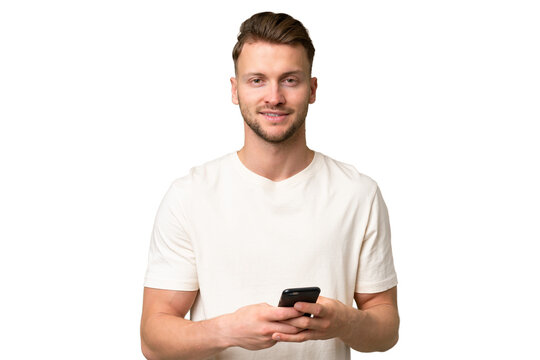 Young blonde caucasian man over isolated background sending a message with the mobile