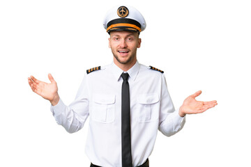 Airplane pilot man over isolated background with shocked facial expression