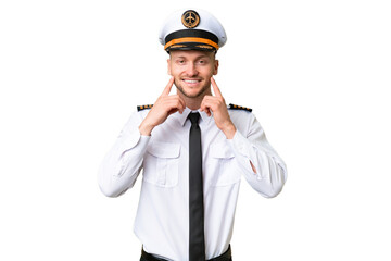 Airplane pilot man over isolated background smiling with a happy and pleasant expression