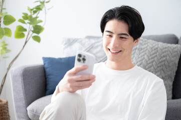 Smiling man with a phone and a nice camera eye with copy space available Up Tap