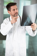 doctor in office looking at xray results