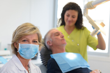 Fototapeta premium portrait of female dentist in dental office