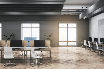 Modern dark concrete and wooden coworking office interior with furniture, equipment, window with city view and sunlight. Workplace and loft space concept. 3D Rendering.