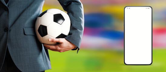 Manager holding a soccer ball and smartphone app