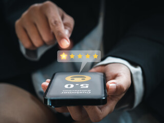 Customer review, satisfaction, feedback, survey concepts. The User giving 5 stars point rating with smile face icon to service experience, business ranking on online application by smart mobile phone.