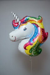 white unicorn foil balloon with helium