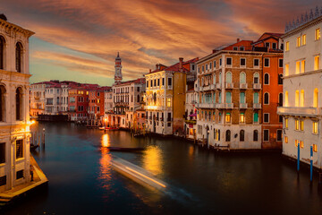 Venice Grand Canal at sunset with boat trails and illuminated historic buildings, long exposure
