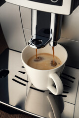 preparing a cup of coffee in a coffee machine