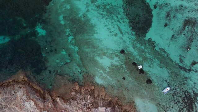 Marine structure healthy reef. Calm aerial view flight tilt up drone
beach formentera island ibiza spain, fall 2022. High Quality 4k Cinematic footage