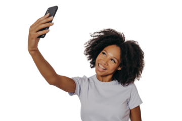 Cheerful young african woman with curly hair taking selfie on her modern mobile phone