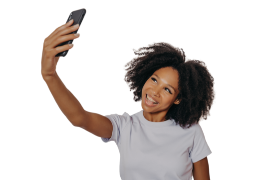 Cheerful young african woman with curly hair taking selfie on her modern mobile phone