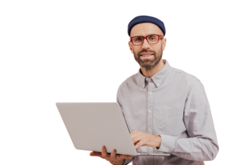 Photo of guy internet user browses website on laptop computer, connected to wireless internet, holds electronic gadget, wears spectacles, formal shirt, isolated over pink background with free space