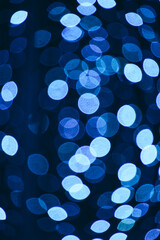 Abstract bright background, bokeh of burning blue light bulbs.