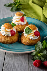 Choux pastries with burnt Swiss meringue, raspberries and mint
