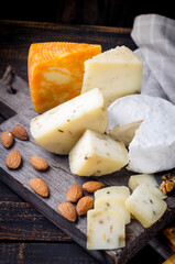 Assorted cheese pieces, vegetables, honey, fruits, cookies and nuts