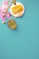 Honey background. Sweet honey in a glass jar and a honey spoon on a wooden table. Copy space for your text