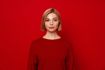 Young blonde woman with short hair looking at camera