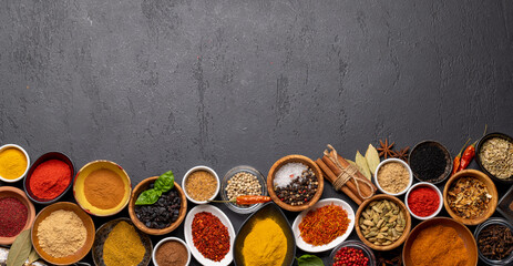 Various spices in bowls on stone table