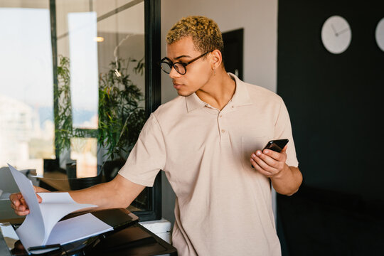 African business man using printer in office
