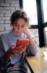 A woman looks at her smartphone