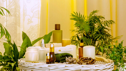 Spa relax still life with beauty products, spa accessories, towels and candles in home interior with plants. Concept of me time, self care and relaxing at home. Soft focus style