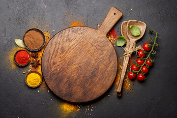 Empty cutting board over various spices