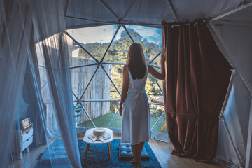 Travel woman relax inside a luxury camping dome tent