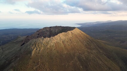 Drone aerial view of Volcán de La Corona is a 609 meters high extinct volcano on the Canary Island of Lanzarote, close to  Yé and  Haría in Canaries island , Spain - crater volcano view 