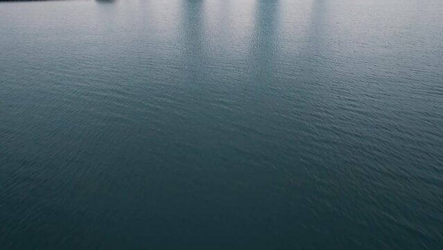 Establishing aerial of milwaukee wisconsin from lake micghigan. Cinematic type shot captured at sunrise. Constraction crane and skysrapers visible. USA