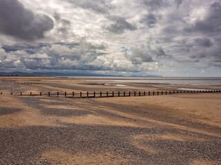 Windfarm and sand patterns on golden sands of Rhyll Beach, Wales, UK
