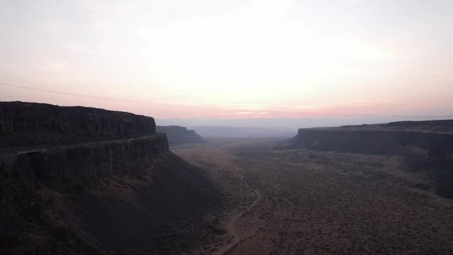 Aerial cinematic view of Frenchmen coulee canyons hills rock formations at sunset, climbers paradise in Washington 