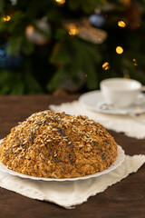 ant hill cake decorated with poppy seeds on a white plate. the concept of a festive tea party