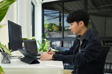 Coding programmer working on software development on desktop computer at modern office
