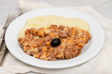 Minced meat and mashed potato on white plate